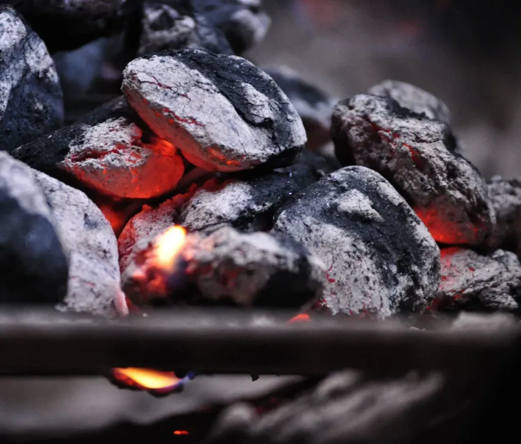 Glowing charcoal briquettes burning for clean cooking fuel